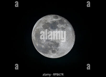Celestial body in the heavens: Waning gibbous Moon (one day after full moon) in the night sky seen from Surrey, south-east England, UK Stock Photo