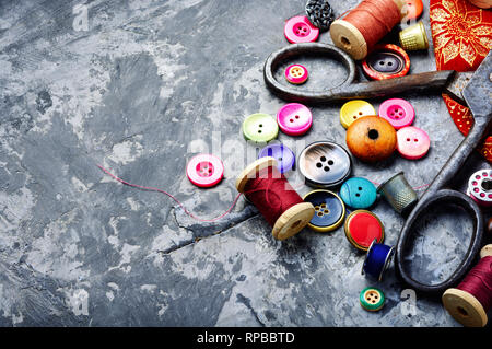 Composition with threads and sewing accessories.Sewing threads, fabric and buttons Stock Photo