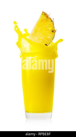 Splash from falling slice in glass of pineapple juice Stock Photo