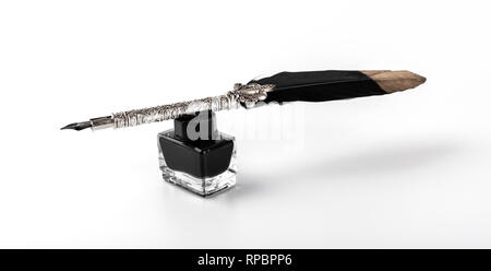 feather quill pen and ink bottle isolated on white background Stock Photo