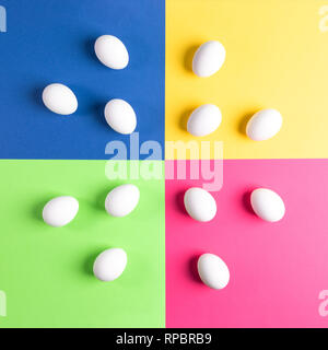 Set of white eggs on colorful four-color background.  Stock Photo