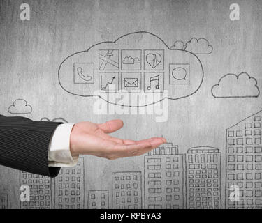 Male hand showing cloud with app icons doodles on concrete wall background Stock Photo