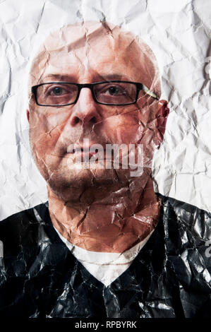 portrait photo of a bald man with eyeglasses crumpled and wrinkled, ageing concept