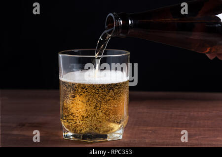 light beer in a glass on a wooden table Stock Photo