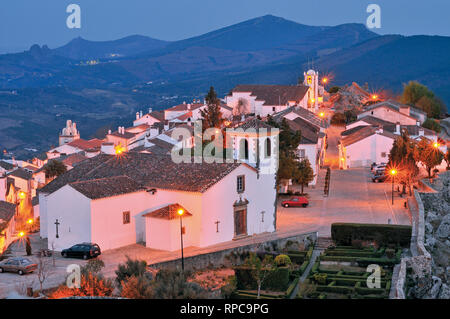 Romantic view of nocturnal illuminated medieval mountain village Stock Photo