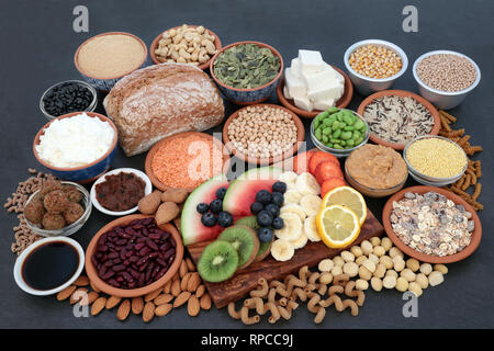 Large vegan health food collection on slate background. Super foods high in antioxidants, protein, vitamins, anthocyanins and dietary fibre. Stock Photo