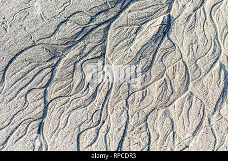 Beach patterns caused by the retreating tide. Stock Photo