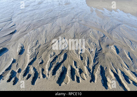 Beach patterns caused by the retreating tide. Stock Photo