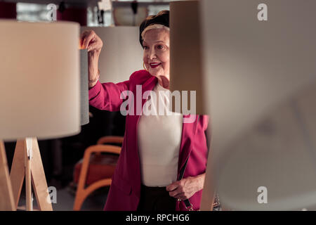 Waist-shot of beautiful aging female having good time in store Stock Photo