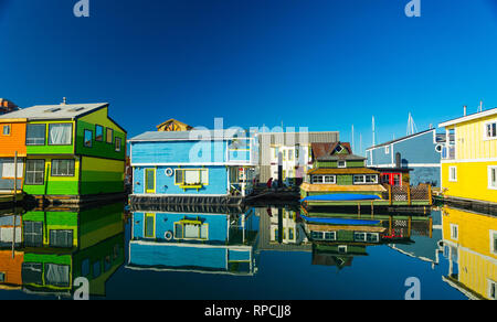 The colorful village of float homes on a bright sunny day, blue sky. Stock Photo