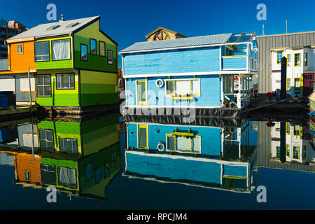 The colorful village of float homes on a bright sunny day, blue sky. Stock Photo