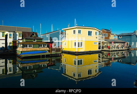 The colorful village of float homes on a bright sunny day, blue sky. Stock Photo