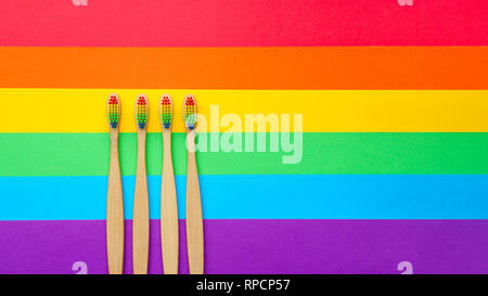 Photo on top of four toothbrushes on rainbow background. Stock Photo