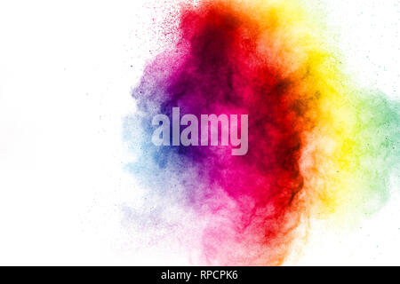 Freeze motion of colored powder explosions isolated on white background.Color dust particle splattered on background. Stock Photo