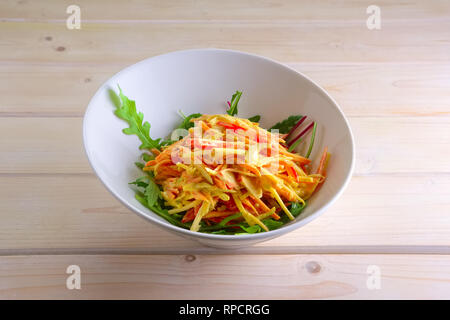 Spring salad with apple, carrot, crab meat, bell pepper and mustard sauce Stock Photo