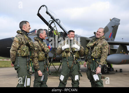 Chief of the Air Staff Air Chief Marshal Sir Stephen Hillier and RAF Marham station commander Group Captain Ian 'Cab' Townsend share a joke with Squadron Leader Chris Whitehair (left) and Wing Commander Matt Bressani (right) fter both completing their final flights in a Tornado GR4 ahead of the aircrafts retirement next month. Stock Photo