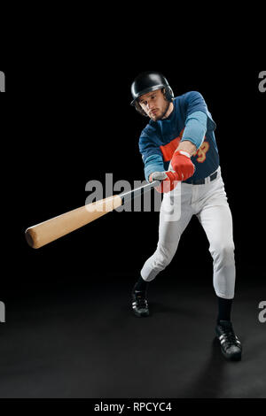 Baseball hitter in action Stock Photo