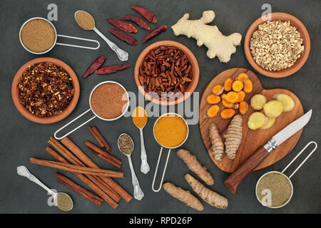 Fat busting spices for losing weight  with fresh and dried turmeric, ginger, cumin, chilli, cinnamon & gymnema sylvestre used to suppress appetite. Stock Photo