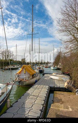 Sailing boats moored on the Lydney canal where it meets the river Severn. Stock Photo