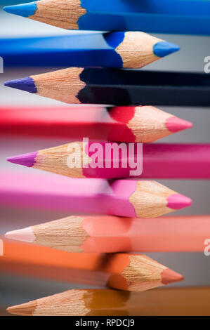 Close-up of writing tips of stacked colorful colored pencils. Stock Photo