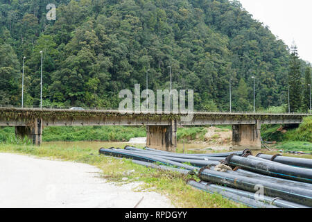 View of concrete bridge with lush green jungle in the background - image Stock Photo