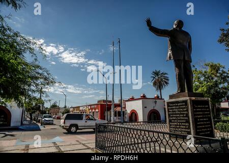 Statue of Luis Donaldo Colosio Murrieta, former presidential candidate for the PRI in Mexico, was assassinated during the electoral campaigns in 1994. He is in the Monumental Plaza of Mgdalena de Kino in Sonora, next to the Temple of Santa María de Magdalena. The church was built on the site of a mission church originally established by the Jesuit missionary Francisco Eusebio Kino. The temple is a spiritual and cultural focal point for the community of Magdalena de Kino. A sanctuary of the patron saint San Francisco Javier is located near the temple of Santa María. The chapel is a popular site Stock Photo