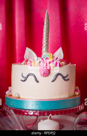 Sweet table and big unicorn cake for baby girl first birthday.. Stock Photo