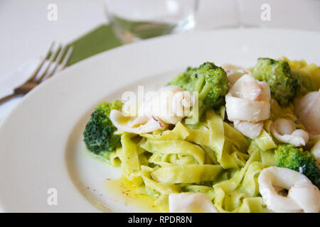 closeup of a light summer italian pasta with broccoli and squid Stock Photo