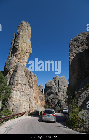 CUSTER STATE PARK, SOUTH DAKOTA - June 9, 2014:  Cars driving on the Needles Highway next to tall quartz rock formations in Custer State Park, SD on J Stock Photo