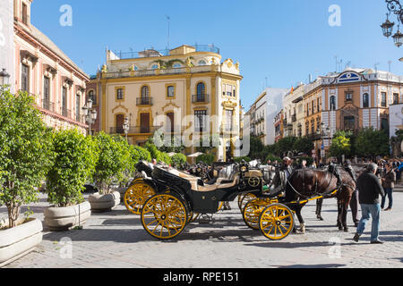 Horse drawn Carriages outside Seville Cathedral waiting to give tourists tours around Seville Stock Photo