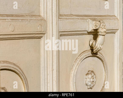 Old carved white door. old palace white wooden door and white metal knocker Stock Photo