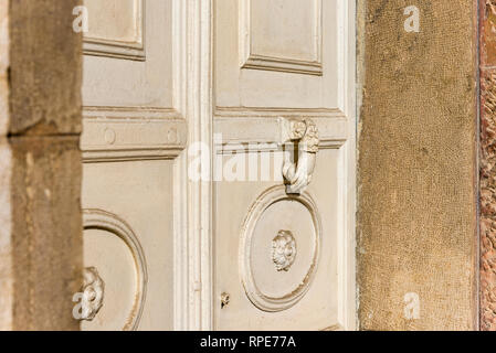 Old carved white door. old palace white wooden door and white metal knocker Stock Photo