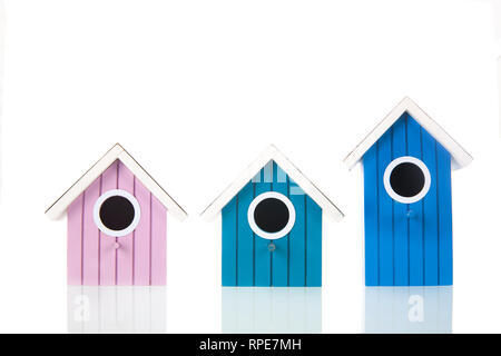 Many colorful bird boxes isolated over white background Stock Photo