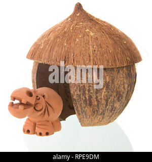 Tropical straw hut with hippo isolated over white background Stock Photo