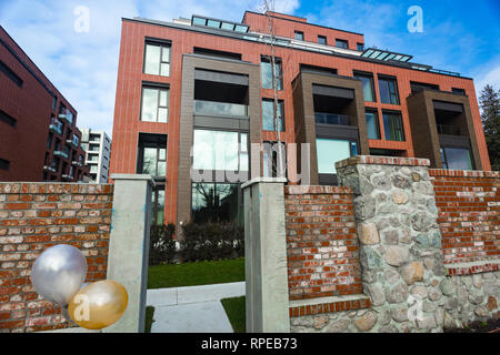 Modern Red Brick Apartment Complex with solid rock fence wall. Home residential buildings complex real estate. Stock Photo