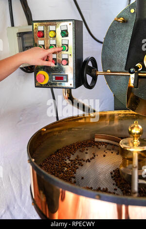 Female Handles Roaster in Organic Coffee production Stock Photo