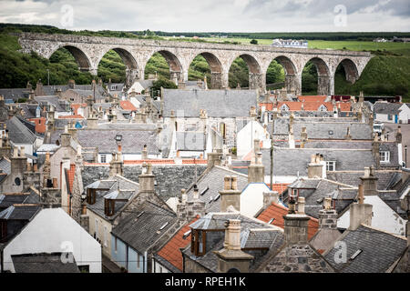 Old croft houses in Cullen, fishing village on Moray Firth, Scotland. Cullen Viaduct in the background, old roofs and chimneys Stock Photo