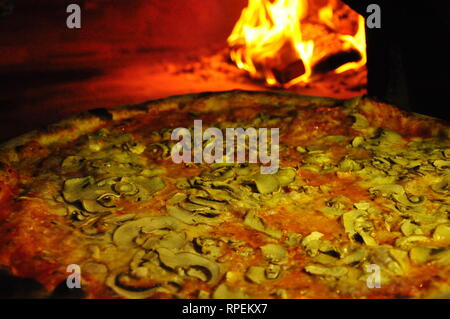 Cooking pizza in professional wood oven Stock Photo