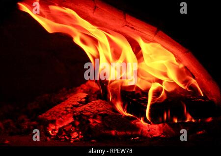 Beautiful wood oven, fire burns in furnace, professional pizza oven Stock Photo