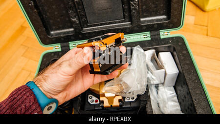 Technician POV at high-precision optical fiber cleaver for cutting optical fiber very precisely during FTTH home and office - modern internet service provider using high-precision tool Stock Photo