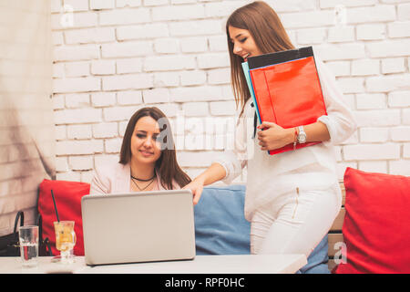 Two young women  making creative solutions together, young male entrepreneurs making plannings cooperating and discussing  new ideas. - Image Stock Photo
