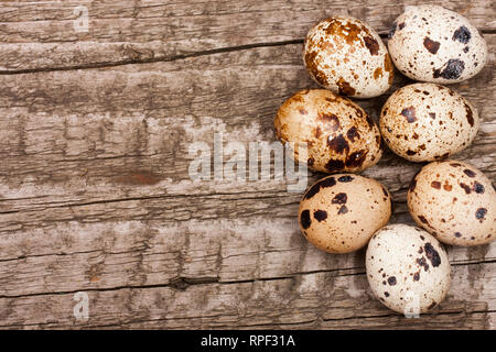 Several quail eggs on old wooden background with copy space for your text. Top view Stock Photo