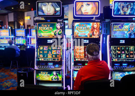 USA, Iowa, Omaha Reservation, Blackbird Bend Casino in Onawa, operated by Native Americans of Omaha Nations, peoples gambling at slot machine, slots Stock Photo