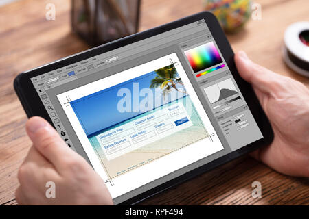 Human Hand Holding Digital Tablet In Office Stock Photo