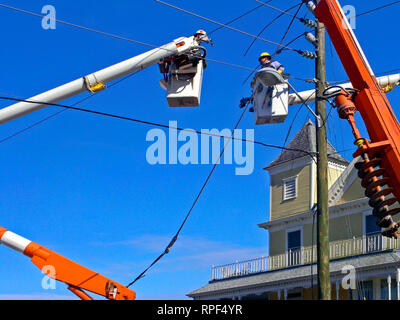 2 linemen, cutting electric wires; bucket trucks; occupation; work; job ...