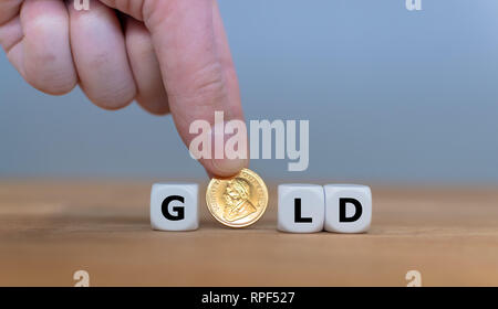 Dice and a Krugerrand coin form the word 'GOLD'. Stock Photo