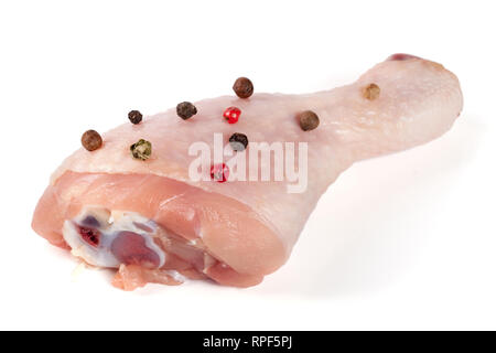 raw chicken drumstick with peppercorns isolated on white background Stock Photo