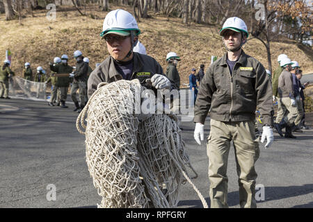 Tokyo, Japan. 22nd Feb, 2019. Zookeepers take part during an Escaped Animal Drill at Tama Zoological Park. The annual escape drill is held to train zookeepers what to do in the event of an animal escape. This year a member of staff wearing an orangutan costume was captured and subdued with large nets, sticks and tranquilizer guns to make sure the orangutan did not get away. Credit: Rodrigo Reyes Marin/ZUMA Wire/Alamy Live News Stock Photo