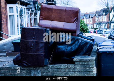 Pile of old used beds on the street. Used beds for trash on the street Stock Photo