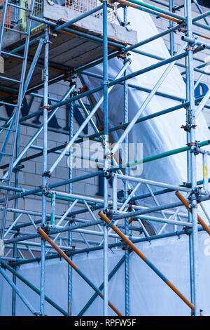 The steel scaffold is set up on a renovated building. Construction site with steel scaffolds Stock Photo